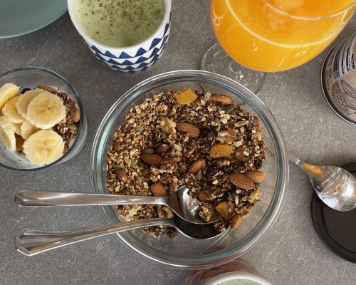 Homemade muesli, matcha latte and fresh juice